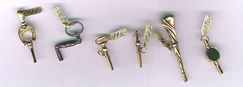 Some pocket watch keys, the two in the centre are equipped with a ratchet arrangement to wind in one direction only. 